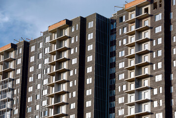 Insulation of external wall of new multi-storey house. Thermal insulation with rock wool of new...