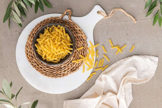 Dry italian fusilli pasta on kitchen countertop. Top-view.