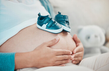 Mother with pregnant stomach in hands, shoes for baby with pregnancy, relax and waiting for birth...