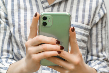 Female hands using smart phone.woman holding mobile phone checking social media,news,texting message