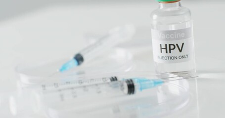 Video close up of hpv vaccine vial and syringes, with copy space