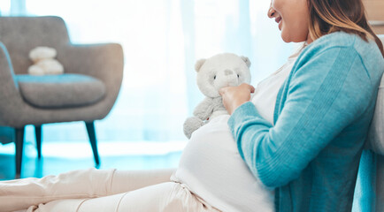 Relax, happy and pregnant woman with teddy bear in baby nursery excited for motherhood. Pregnancy belly of girl resting on floor in home with smile holding fluffy toy for future child.