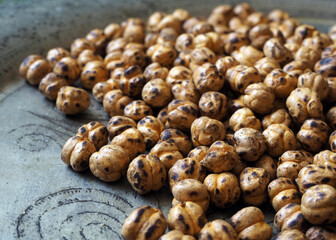 Close up Turkish leblebi. Leblebi is a healthy snack made from roasted chickpeas. Leblebi, traditional Turkish nuts (roasted chickpea) on local motifs.    