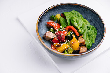 meat with grilled vegetables in bowl