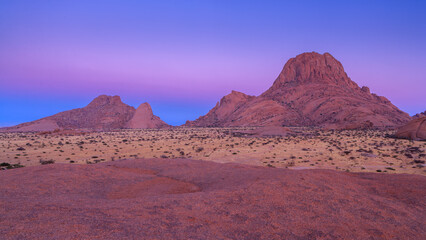 Fototapeta na wymiar The strongly eroded Spitzkoppe mountain chain in the blue hour before sunrise