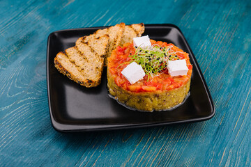 Quinoa salad with tomato and avocado tartare and eggplant