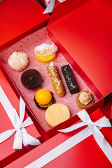 Christmas gifts presents with different cakes on red background