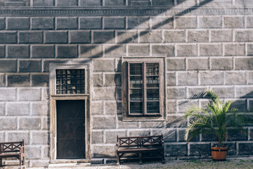 Stone walls, windows, benches, wooden doors and sunlight Cesky Krumlov, Czech Republic
