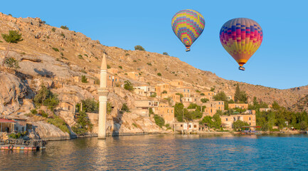 Hot air balloon flying over Historical Halfeti town and  mosque along Euphrates River - Gaziantep,Turkey