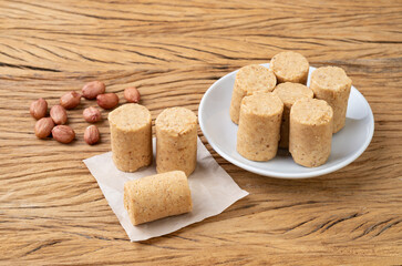 Pacoca, typical brazilian peanut candy and june festival food over wooden table
