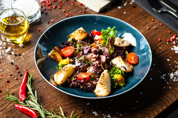 Warm chicken liver salad with port wine-honey sauce. Carrot cream, bacon, cherry tomatoes, brioche. Delicious healthy traditional food closeup served for lunch in modern gourmet cuisine restaurant