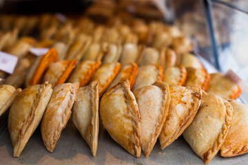 freshly baked empanadas with different fillings for sale