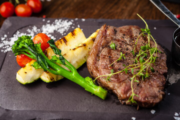 Black Angus New York steak. Marbled beef sirloin from Uruguay. Delicious healthy traditional food closeup served for lunch in modern gourmet cuisine restaurant