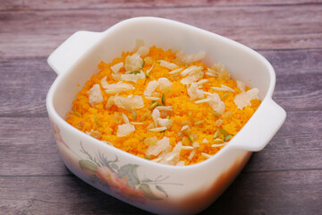 A big white bowl filled with tasty Jollof Rice served 