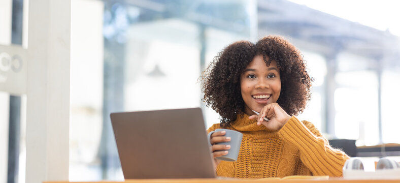 Young Beautiful African Student Girl Working, Learning In Computer And Device Studying Online.