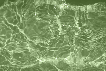 Defocus blurred transparent green colored clear calm water surface texture with splashes and bubbles. Trendy abstract nature background. Water waves in sunlight with copy space. Blue watercolor shine