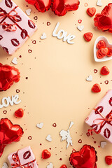 Valentine's Day concept. Top view vertical photo of gift boxes heart shaped balloons candies inscription love cupid silhouette confetti on isolated pastel beige background with copyspace in the middle