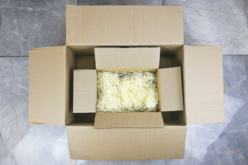 Small Realistic cardboard box opened top view with corrugated cardboard paper pieces instead of...
