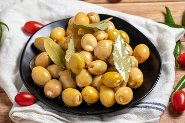 Green olives with cheese filling on a wooden background. Gourmet delicacies. close up