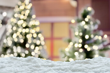 Empty white snow with blur Christmas tree with bokeh light background