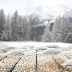 Desk of free space cover of snow flakes and winter landscape of mountains. 