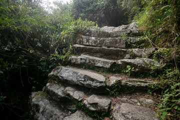 Walking towards the city of Machu Picchu by the Inca trail. Stone staircase.