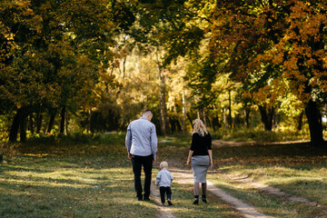 happy family playing and laughing in autumn park