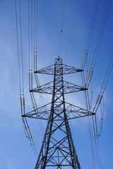 electric power lines. Steel frame of electricity pylon under blue sky. Energy costs