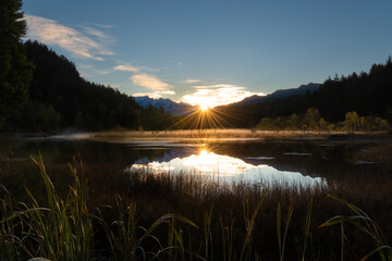 Sun reflection in the alpine pond - 552368174