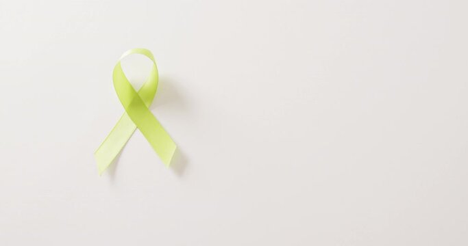 Video of pale green std awareness ribbon on white background with copy space