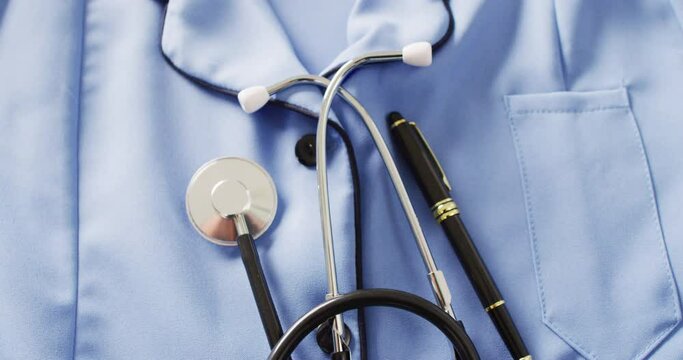 Video of stethoscope and pen on blue nurse's uniform shirt