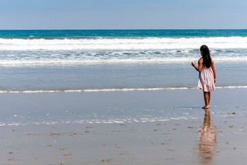 girl from behind motañita beach in guayas ecuador
