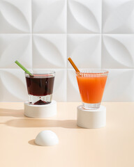 Two healthy  morning fresh drinks from berries and grapefruit on beautiful white and beige background