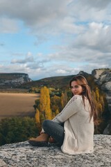Fototapeta premium Beautiful girl posing in nature. Autumn photo session in nature.