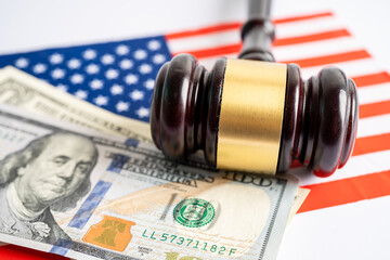 Gavel for judge lawyer and US dollar banknotes on USA America flag, finance concept.