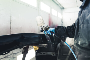 White spray booth interior. Process of automobile painting. Car fender varnishing. Unrecognizable...