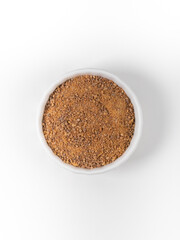 Coconut brown sugar in a bowl close up isolated on white
