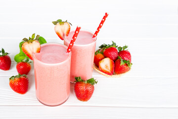 Strawberry yogurt fruit juice smoothie pink colorful fruit juice milkshake blend beverage healthy high protein the taste yummy In glass drink episode morning on white wood background.