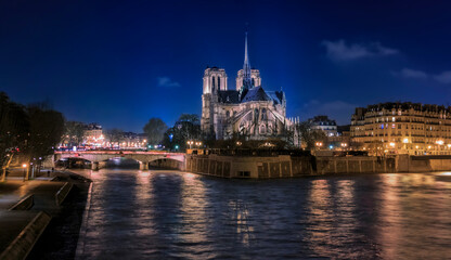 Obraz premium Illuminated Notre Dame de Paris Cathedral with the spire, before the fire at night, world most famous Gothic Roman Catholic cathedral in Paris, France
