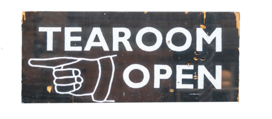 Old style Tearoom Open sign with hand pointing to left, painted on a black painted wooden board board that has chips and splits