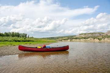 Canoe on banks of Red Deer River, Alberta