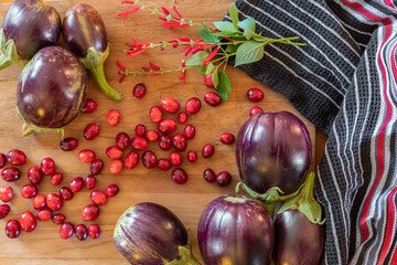 Eggplants harvested from the garden and cranberries for a recipe.