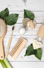 Fototapeta na wymiar Eco friendly cosmetic set of bamboo hairbrush, comb, toothbrush, shampoo bar and organic soap and lotion. Sustainable bathroom accessories