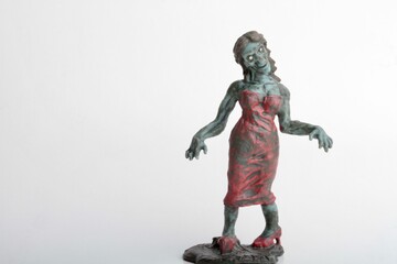 miniature figurine of a zombie doll on a white background