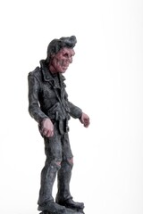 miniature figurine of a zombie doll on a white background