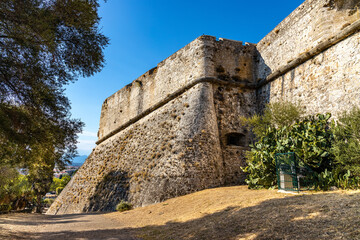Defense walls and towers of medieval fortress Fort Carre castle in Antibes resort city onshore Azure Cost of Mediterranean Sea in France - 552380387
