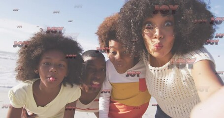 Animation of christmas greetings text over biracial couple with son and daughter on beach