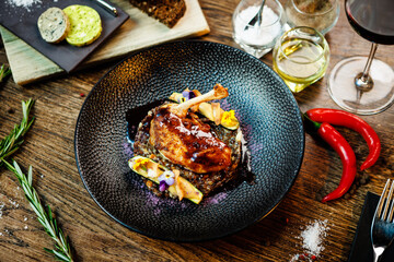 Corn chicken supreme. Beluga lentils, Old Ammerlander cheese, mini zucchini, red wine sauce. Delicious healthy traditional food closeup served for lunch in modern gourmet cuisine restaurant