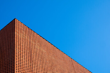 Decorative brick wall on exterior vintage building wall with net covering to prevent the building from getting dirty from birds