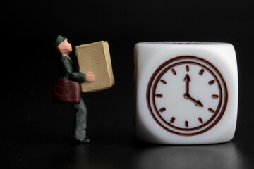 miniature figurine of a delivery man with a parcel and the symbol of a clock